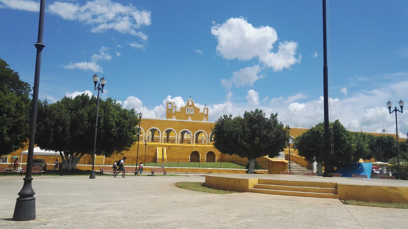 yellow buildings around plaza, walls stairs, all in same tone