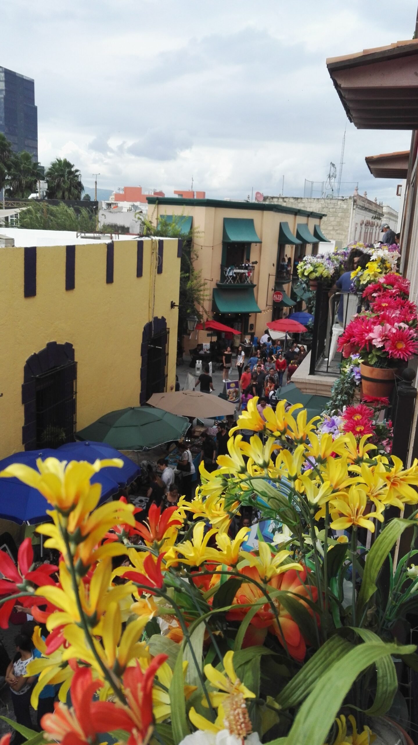 bussing streets with colourful flowers and umbrellas from above
