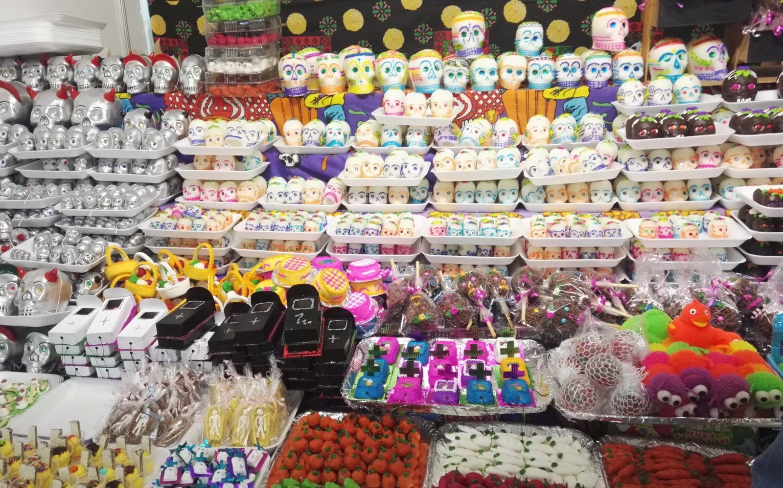 display with many sugar skulls, skeletons and more colourful