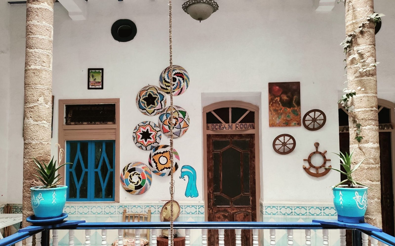 Hostel interior, gallery with wooden banisters, local crafts decor